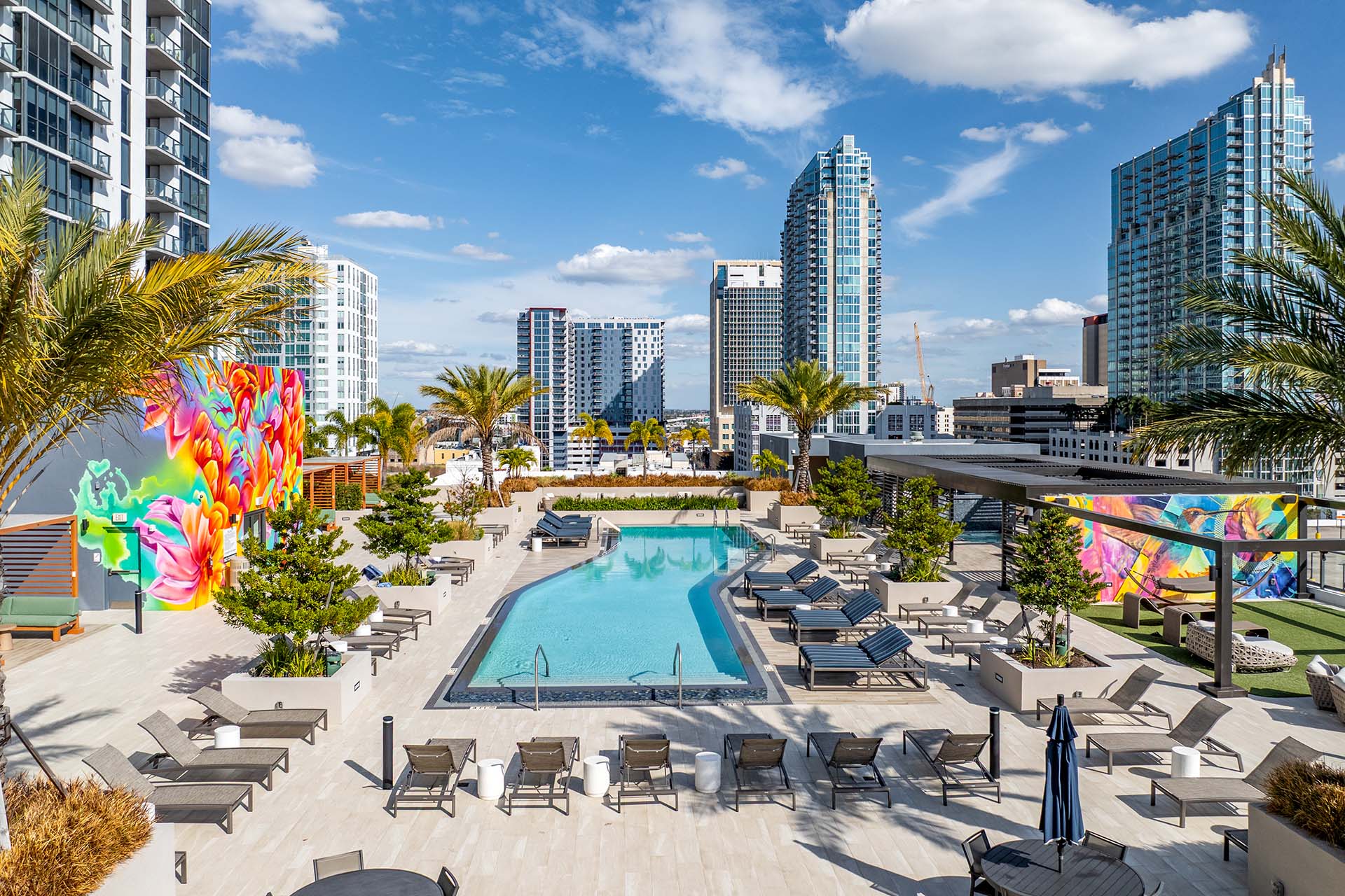 Aer Tampa rooftop pool deck with colorful mural and lounge chairs.