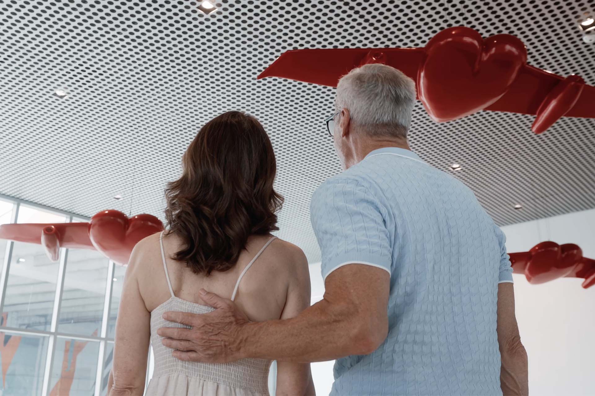 Older couple looking at pop art at Tampa art museum.