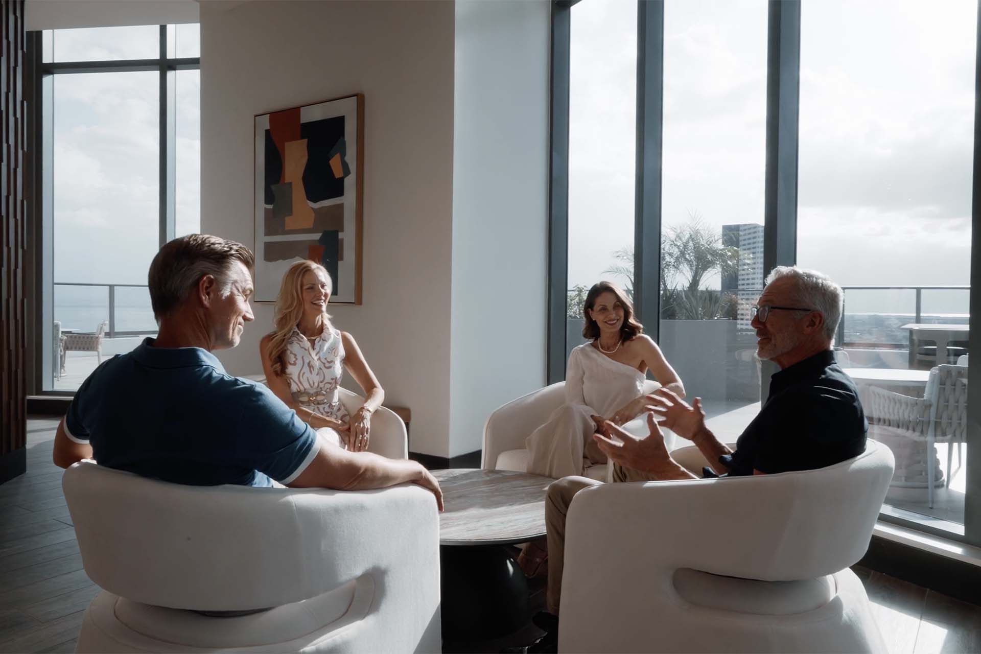 Two older couples talking together in Aer community lounge.
