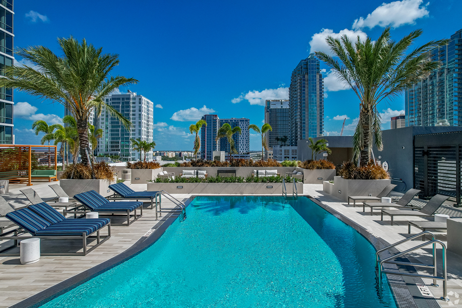 Aer rooftop deck with glistening pool and lounge chairs.