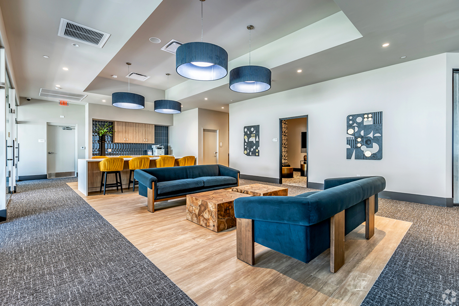 Aer community lounge with plush seating and community coffee bar.