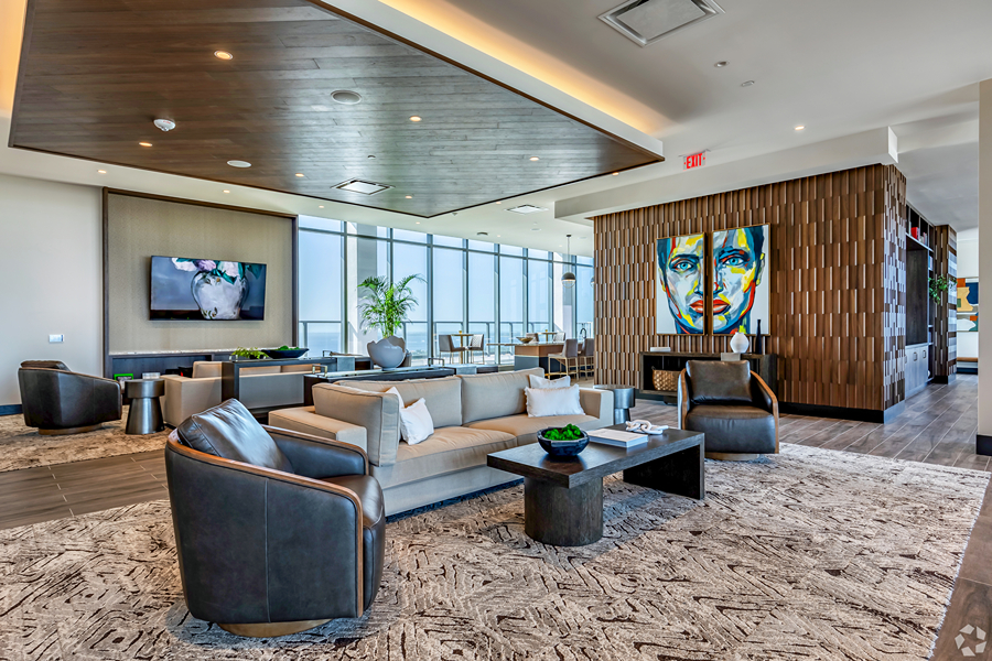 Aer community lounge with plush seating and colorful artwork.
