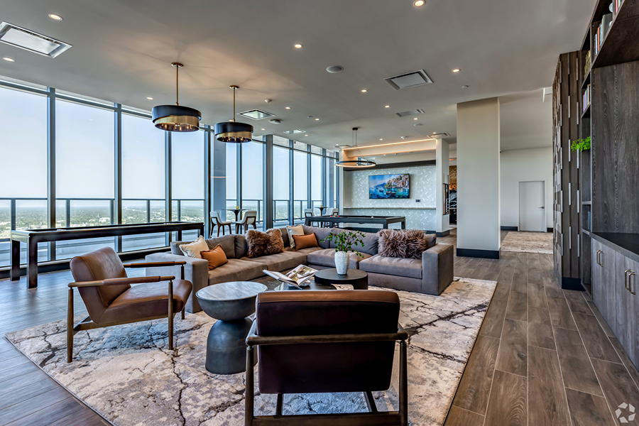 Aer community lounge with plush seating and shuffleboard and billiards tables.
