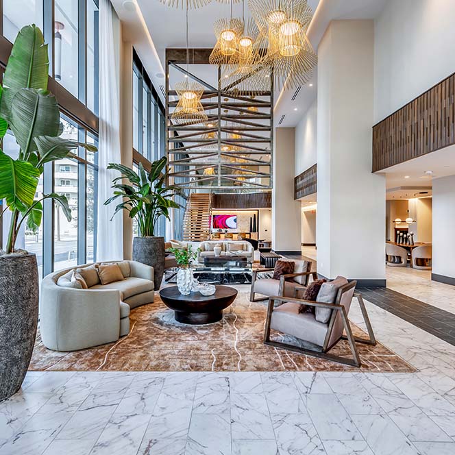 Aer community lounge with plush seating and airy lofted ceilings.