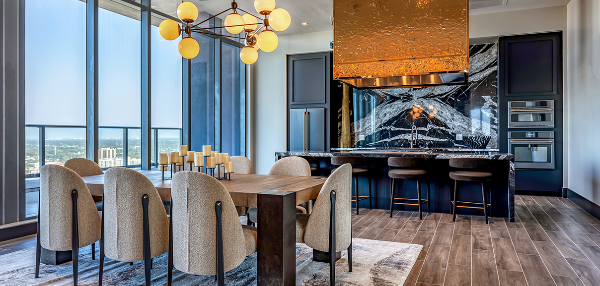 Aer community kitchen with elegant dining table and chef's kitchen.