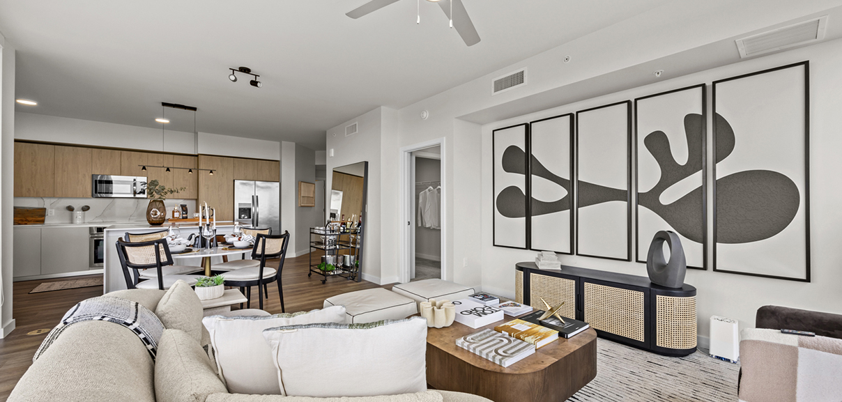 Aer apartment living area with plush seating and dining table.