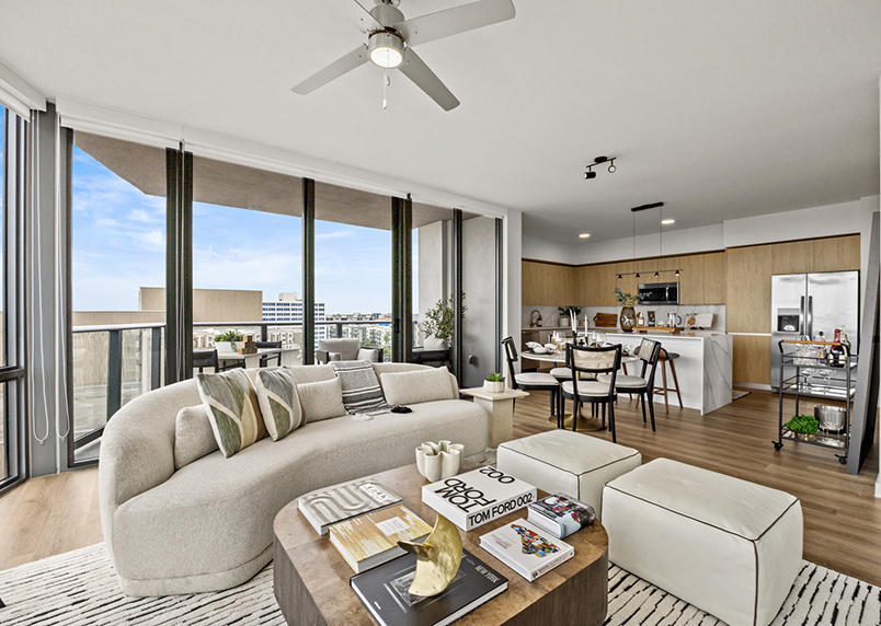 Aer apartment living area with plush seating, elegant dining, and modern kitchen.