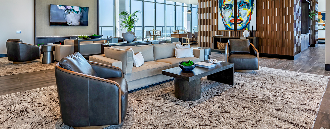 Aer community lounge with plush seating and colorful artwork.